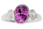 The ring-contemporary is a silver ring with a large oval-cut purple gemstone at the center, accented by two smaller round clear stones.