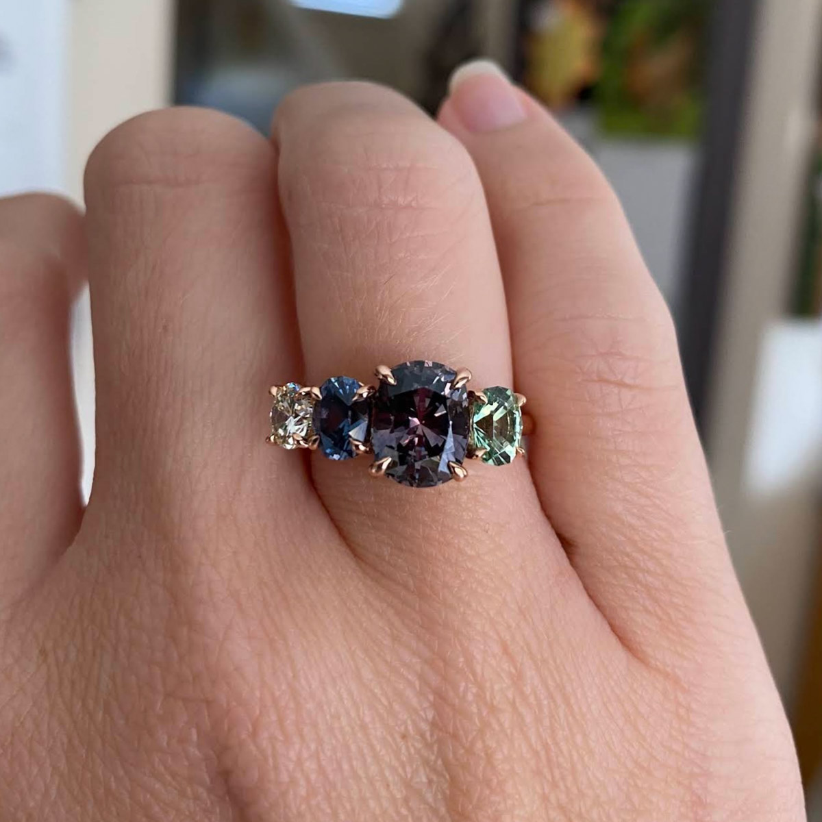 Custom ring in 14K rose gold with client-provided purple sapphire and heirloom diamond, as well as 0.82-carat Umba sapphire and 0.61-carat kornerupine