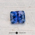 A rectangular, deep blue 0.80-carat heated Montana sapphire with intricate faceting rests on a light textured surface; the "Earth's Treasury" logo appears at the bottom.