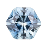 A close-up of the shape-fancy, a faceted light blue gemstone with a hexagonal design, shown on a plain white background—an ideal addition to any gemstone collection.