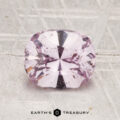 A 1.81-carat Ceylon sapphire is displayed on a textured light gray surface, with "EARTH'S TREASURY" text below.