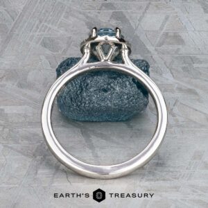 The "Alice" ring in platinum with a 1.09-carat Montana sapphire displayed on a rock.