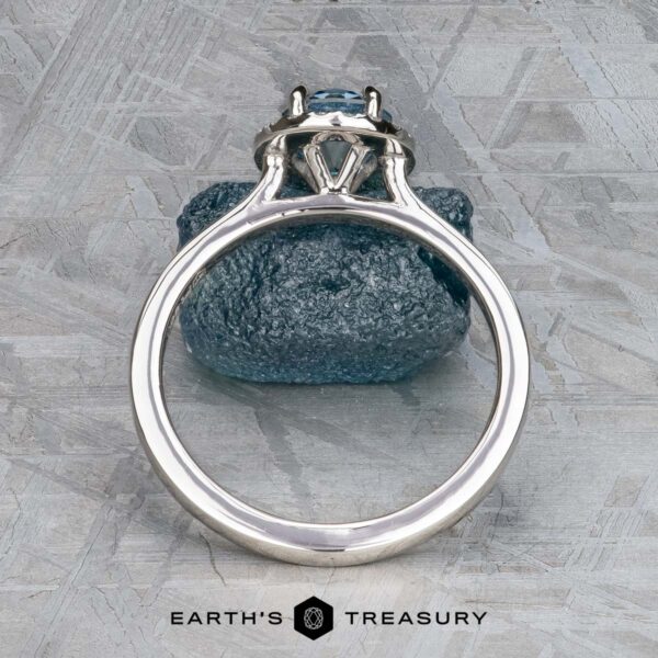 The "Alice" ring in platinum with 1.09-carat Montana sapphire The "Alice" ring in platinum with a 1.09-carat Montana sapphire displayed on a rock.