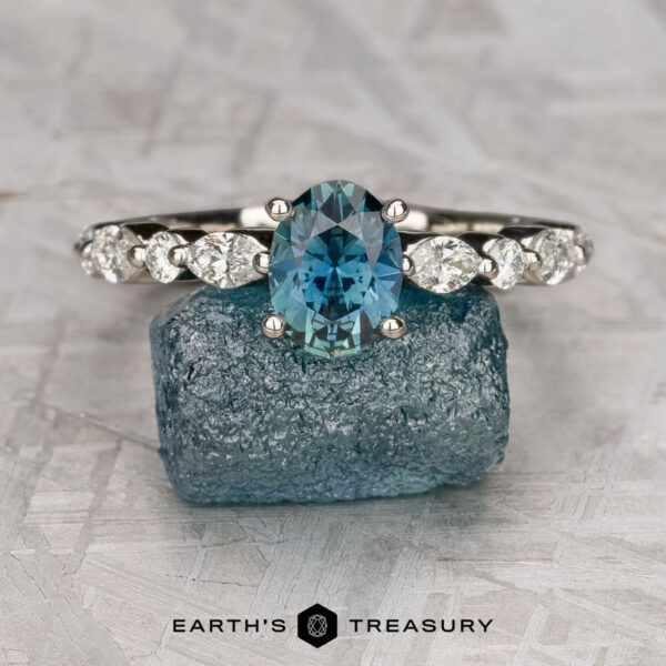 The "Clemencia" ring in platinum with 1.07-carat Montana sapphire The "Clemencia" ring in platinum with a 1.07-carat Montana sapphire rests on a rough blue crystal, with the "Earth's Treasury" logo below.