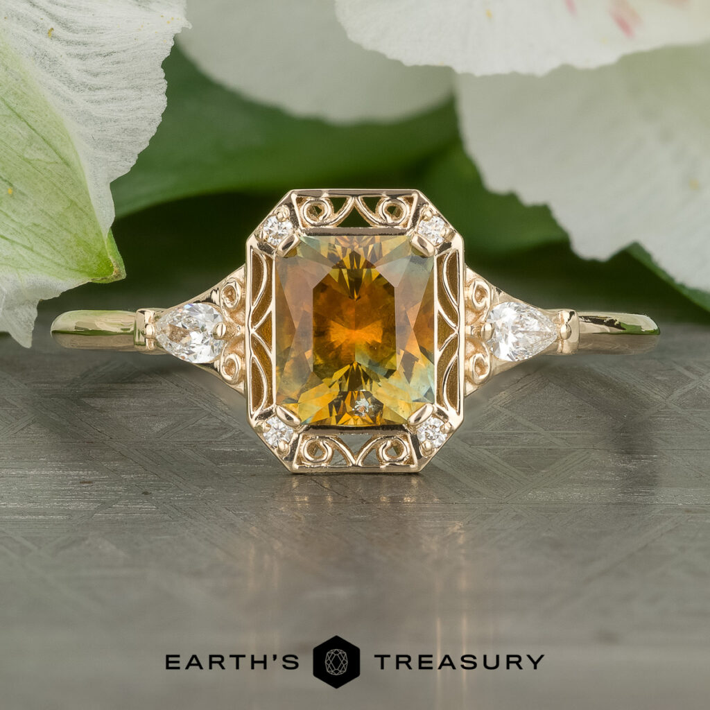 The "Stacked from 20 images. Method=B (R=14,S=2)" is a gold ring featuring an emerald-cut yellow-green gemstone, two pear-shaped side diamonds, and ornate detailing, shown on a patterned surface with white flowers behind.