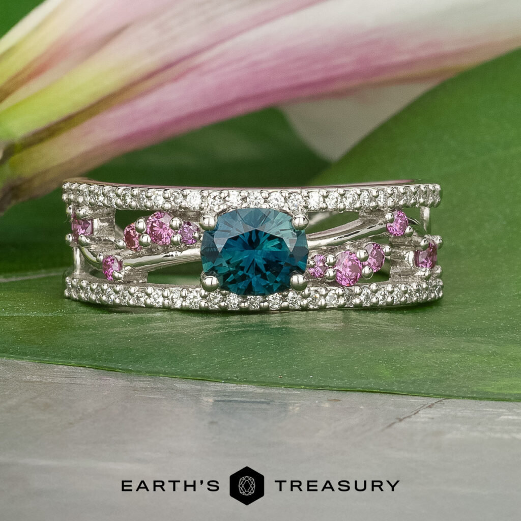 The product "Stacked from 16 images. Method=B (R=14,S=2)" is shown: a silver ring with a large blue center stone, small pink and clear accent stones, set on a green leaf with a flower in the background.