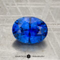 A 2.07-carat heated Ceylon sapphire, faceted in an oval shape, displayed on a textured surface with "Earth's Treasury" at the bottom.