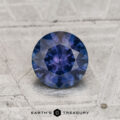A 1.04-Carat Montana Sapphire (Heated) is shown on a textured gray surface, with "Earth's Treasury" featured at the bottom.
