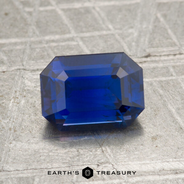 2.02-Carat Ceylon Sapphire A 2.02-carat Ceylon Sapphire, cut in a rectangular faceted shape and displayed on a textured surface, with the text "Earth's Treasury" beneath it.