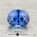 A 2.29-carat heated Ceylon sapphire with an oval cut is displayed on a textured surface, with "EARTH'S TREASURY" featured below.