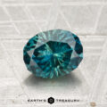 A 1.83-carat Montana Sapphire (Heated), round brilliant-cut and teal in color, is displayed on a textured light surface with "Earth’s Treasury" at the bottom.