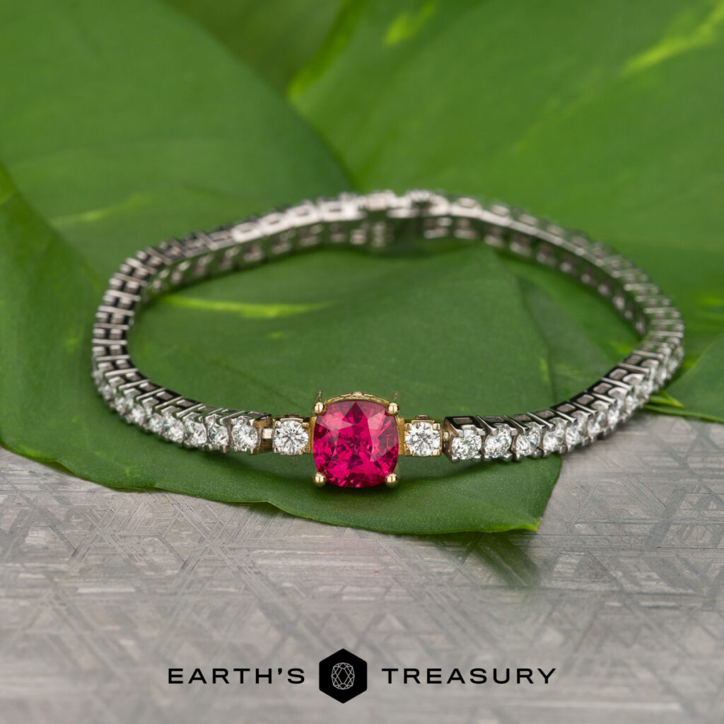 Seiglie, Dania 6 bracelet: features a large pink gemstone center with multiple clear round stones, showcased on green leaves with "EARTH'S TREASURY" text below.