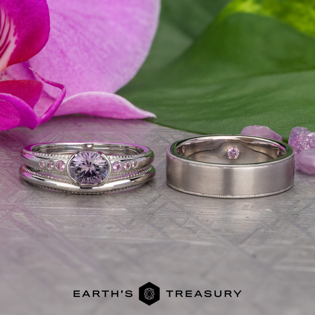 Two silver rings with pink gemstones are displayed side by side on a textured surface, with a pink orchid and stones in the background. At the bottom is the "EARTH'S TREASURY" logo. Product: Stacked from 41 images. Method=B (R=11, S=7).