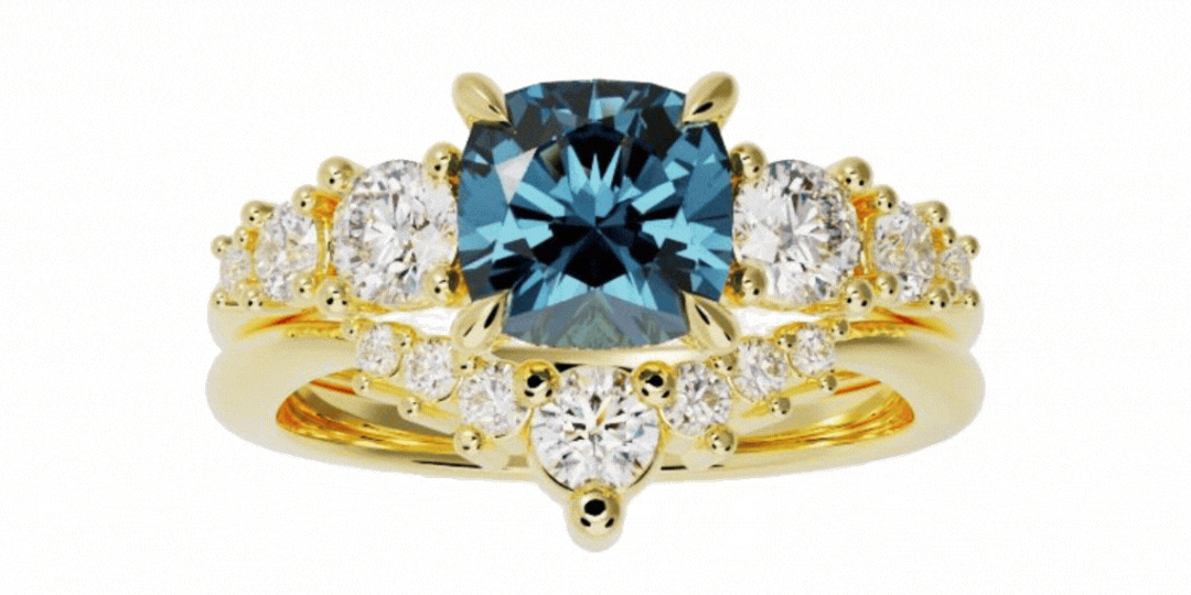 The 3-Wedding-Bands-GIF-cropped features a gold ring set with a prominent blue center stone, accented by several round white diamonds arranged symmetrically.