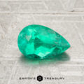 A 1.16-carat Colombia Emerald (oiled), cut in a faceted pear shape, is showcased on a textured gray surface with the "Earth's Treasury" logo at the bottom.