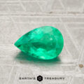 A 0.98-carat pear-shaped green Colombia emerald (oiled) is displayed on a textured light gray surface with the Earth’s Treasury logo at the bottom.