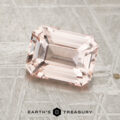 A rectangular, peack pink 2.05-carat unheated sapphire with beveled edges rests on a textured metallic surface. "EARTH’S TREASURY" is printed at the bottom of the image.