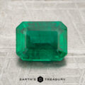 A 1.72-carat emerald-cut green gemstone is displayed on a textured surface with the Earth's Treasury logo beneath it.