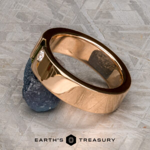 The “Stacked from 53 images. Method=B (R=1,S=3)” ring is shown in polished gold with a diamond, set atop a dark textured stone on a patterned surface. The "Earth's Treasury" logo and text are visible at the bottom.