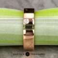 A gold ring with a small round diamond and a rectangular green gemstone set in the center, displayed on a green and white striped surface. "Stacked from 41 images. Method=B (R=1,S=3)" logo appears at the bottom.