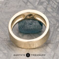 Introducing the ET Stock ring: a stunning piece in 14K yellow gold, featuring a brilliant blue gemstone at its center. Displayed upright on a textured gray surface with the “Earth’s Treasury” logo beneath, this exquisite ET Stock ring is ready to ship.