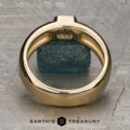 A ring titled "Stacked from 49 images. Method=B (R=7, S=2)" stands upright on a textured gray surface, framing a rough blue-green stone. The "Earth's Treasury" logo and text appear at the bottom of the image, highlighting this stunning piece as Ready to Ship.