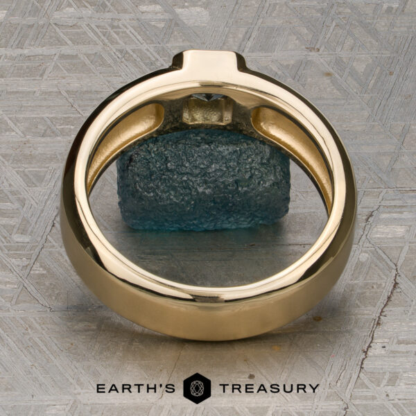 A ring titled "Stacked from 49 images. Method=B (R=7, S=2)" stands upright on a textured gray surface, framing a rough blue-green stone. The "Earth's Treasury" logo and text appear at the bottom of the image, highlighting this stunning piece as Ready to Ship.