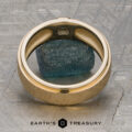 A Stacked from 48 images. Method=B (R=7,S=2) ring crafted in 14K Yellow Gold, featuring a blue rough gemstone at its center, is displayed on a textured metallic surface with a delicate Florentine Finish. The logo and text "Earth's Treasury" appear at the bottom.