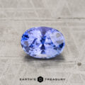 A 2.23-carat faceted oval blue sapphire rests on a textured gray surface, with the text "Earth's Treasury" and a geometric logo displayed below.