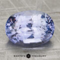 Unheated 4.12-carat oval-cut light violet sapphire with facets rests on a textured surface. "EARTH'S TREASURY" logo and text appear at the bottom of the image.