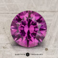 A 3.12-carat Pastel Pyrope Garnet, round and faceted, is shown on a textured, light background with "EARTH'S TREASURY" at the bottom.