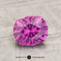 A faceted 1.91-Carat Pastel Pyrope Garnet with internal inclusions rests on a textured, light surface. "EARTH'S TREASURY" is printed at the bottom.