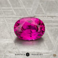 A 1.29-carat Vietnamese Ruby (heated), faceted oval and pink, rests on a textured metallic surface with "Earth's Treasury" below.