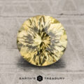 A 2.29-carat unheated greenish-yellow Kenya sapphire is displayed on a textured gray surface with the Earth's Treasury logo and text below.