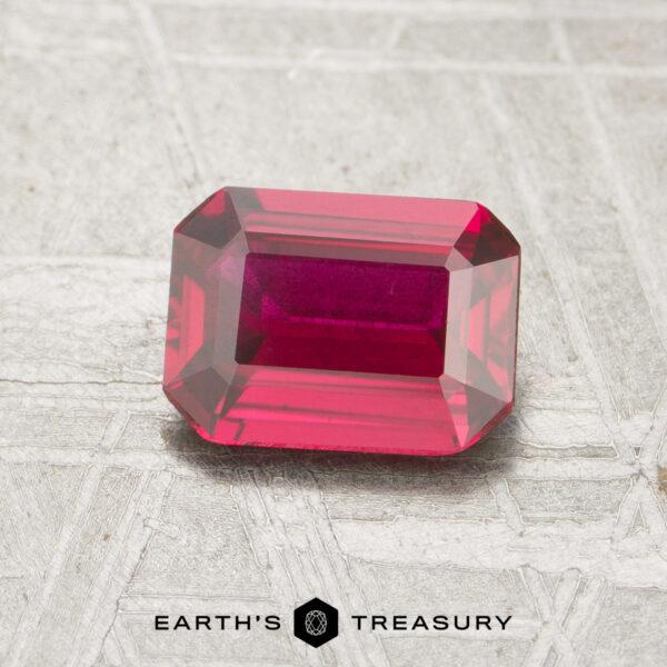 1.16-Carat Ruby A 1.16-carat, rectangular emerald-cut ruby is displayed on a light, textured surface with the "Earth's Treasury" logo at the bottom.