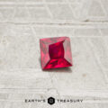 A 0.30-carat square-cut ruby is displayed on a textured gray surface with the text "Earth's Treasury" at the bottom.