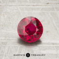 A 1.12-carat round, faceted ruby is displayed on a textured light gray surface. The "EARTH'S TREASURY" logo is shown at the bottom of the image.