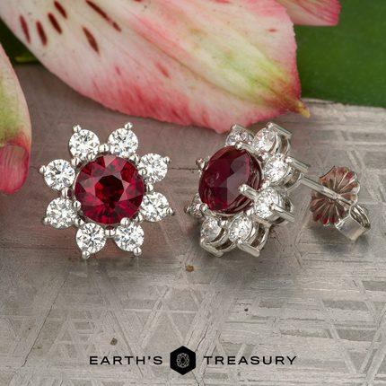 Image (1) showcases floral stud earrings featuring round red center stones encircled by clear gemstones, set in silver metal and displayed on a textured surface near a pink flower.
