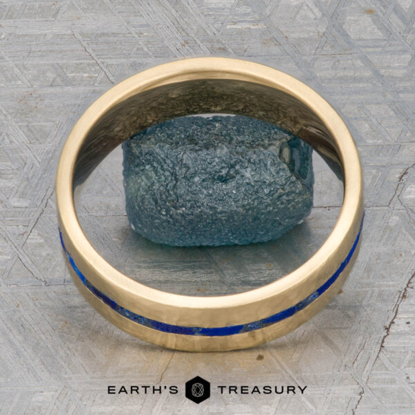 The "Poseidon" Ring A "Stacked from 55 images. Method=B (R=14,S=2)" gold ring with a blue inlay is displayed upright around a rough blue stone on a textured gray surface, with the "Earth's Treasury" logo and name at the bottom.