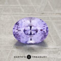 A 1.81-carat faceted oval Ceylon sapphire with a lavender hue rests on a textured light gray surface, with the "Earth’s Treasury" logo displayed at the bottom.