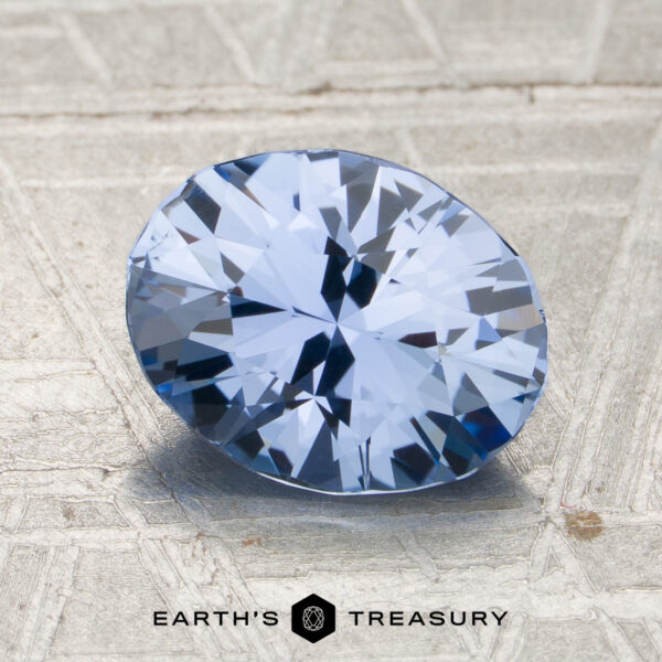 1.92-Carat Sky Blue Ceylon Sapphire (Unheated) A 1.92-carat sky blue Ceylon sapphire (unheated), oval-cut, is displayed on a textured light surface with the text “Earth’s Treasury” below.